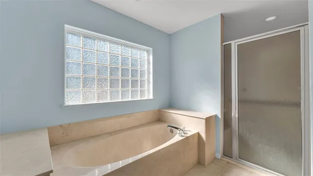 a bath tub sitting in a bathroom next to a window