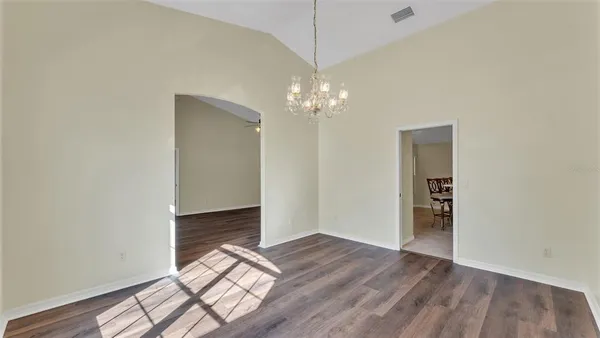 an empty room with wooden floor