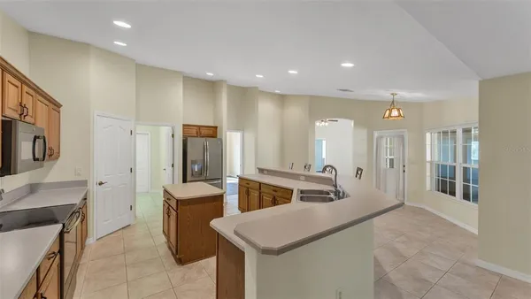 a large kitchen with stainless steel appliances lots of counter space and breakfast area