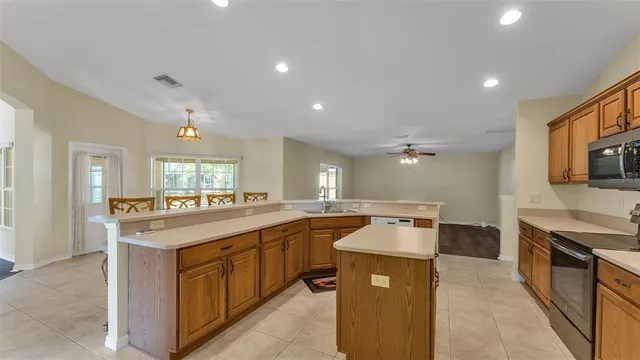 a kitchen with a sink stove top oven and refrigerator