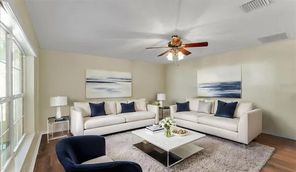 a living room with furniture a chandelier and a table