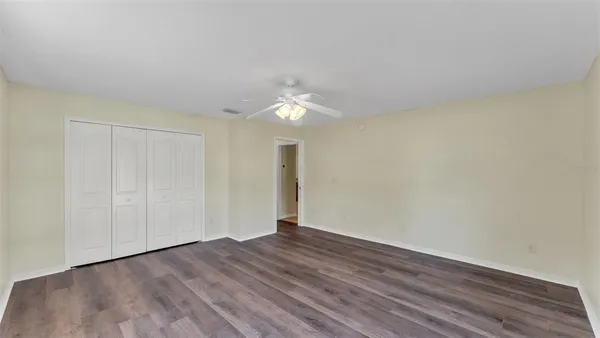 a view of a room with wooden floor and white walls