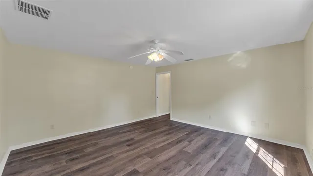 a view of an empty room and wooden floor