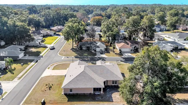an aerial view of a house with a swimming pool