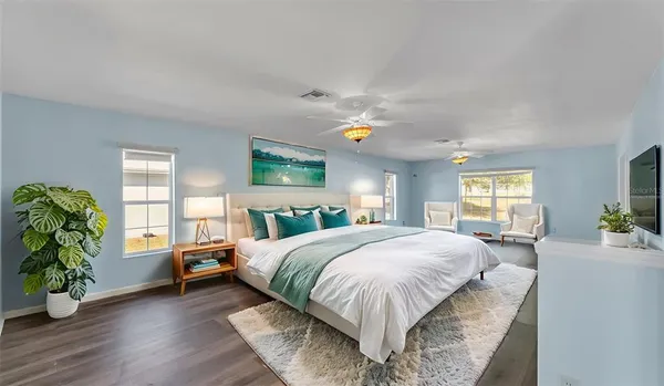 a bedroom with a bed table and a window