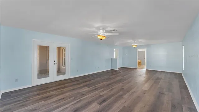 a view of an empty room and wooden floor