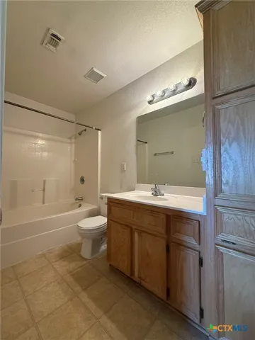 a bathroom with a double vanity sink toilet mirror and bathtub