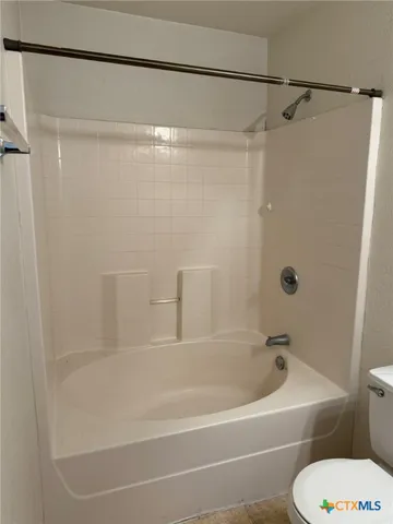 a bathroom with a shower and a toilet