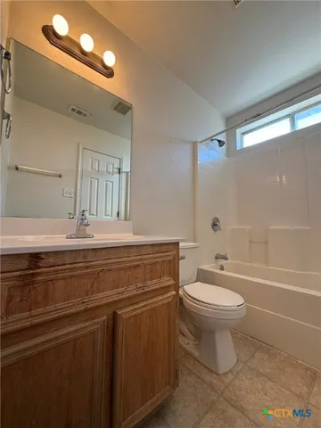 a bathroom with a sink a toilet a mirror and bathtub