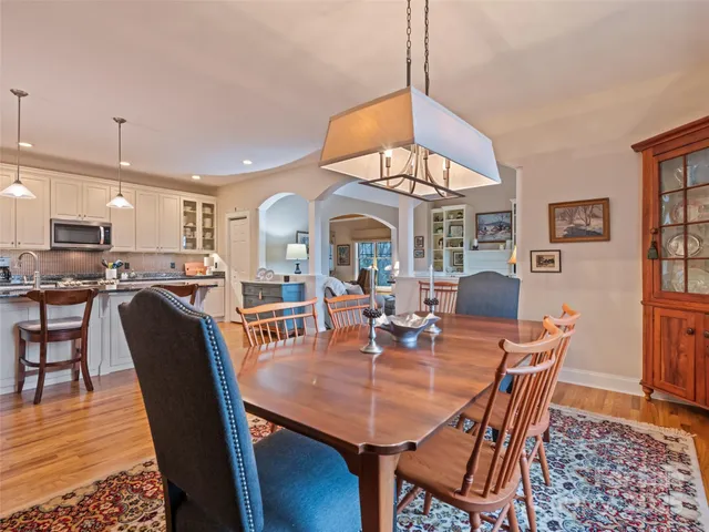 a view of a dining room with furniture and a chandelier