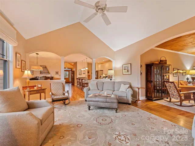 a living room with furniture and a chandelier