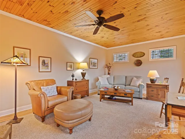 a living room with furniture and a ceiling fan