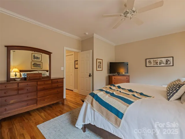 a bedroom with a bed and flat screen tv