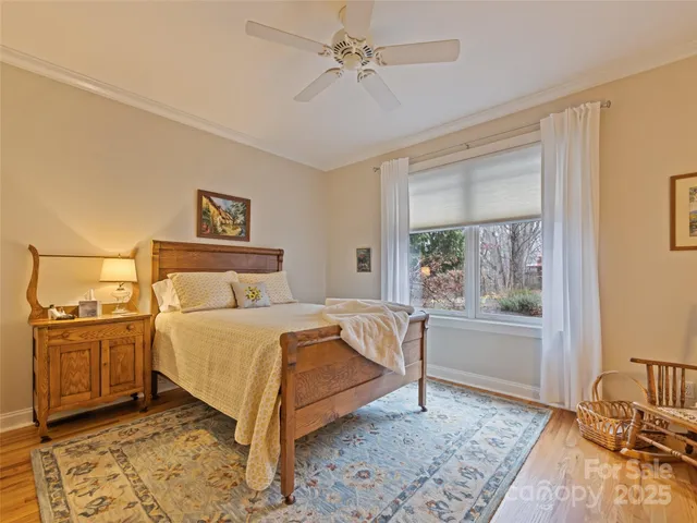 a bed sitting in a spacious bedroom next to a window