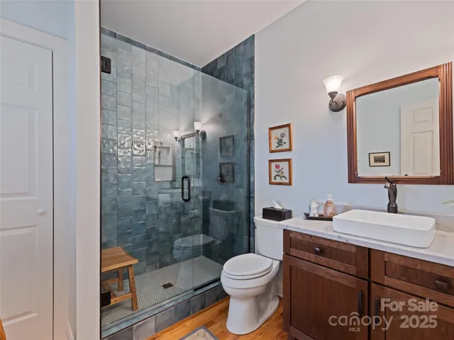 a bathroom with a sink a toilet and shower