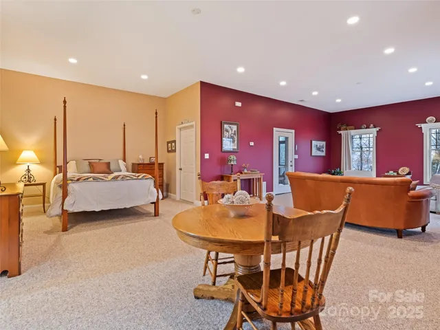 a bedroom with a bed a lamp and a large window