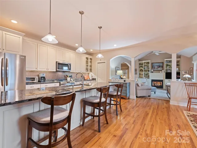 a view of a a dining room with furniture window and wooden floor