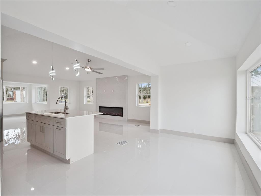 28055 Leuty Road Yalaha, FL 34797 - Photo 11 of 39 a large white kitchen with cabinets and outdoor view