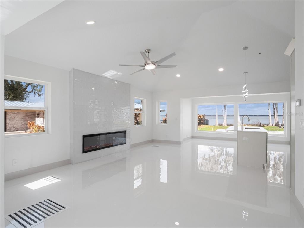 28055 Leuty Road Yalaha, FL 34797 - Photo 14 of 39 a view of open kitchen with kitchen island and stainless steel appliances