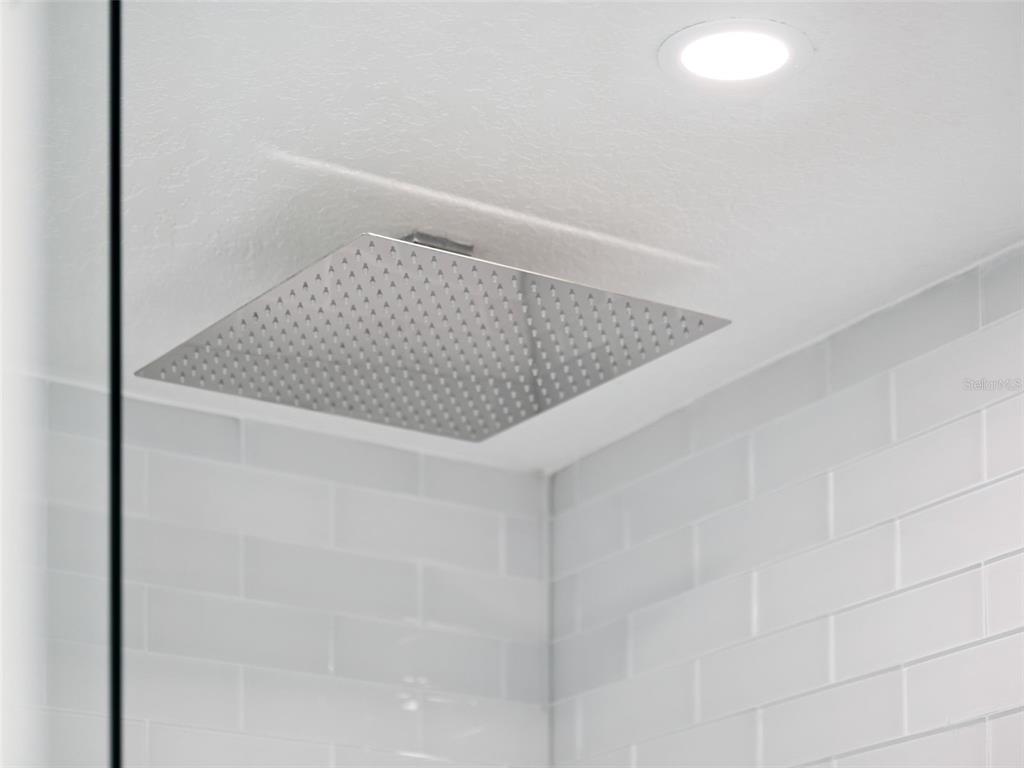 28055 Leuty Road Yalaha, FL 34797 - Photo 19 of 39 a bathroom with a granite countertop sink and mirror