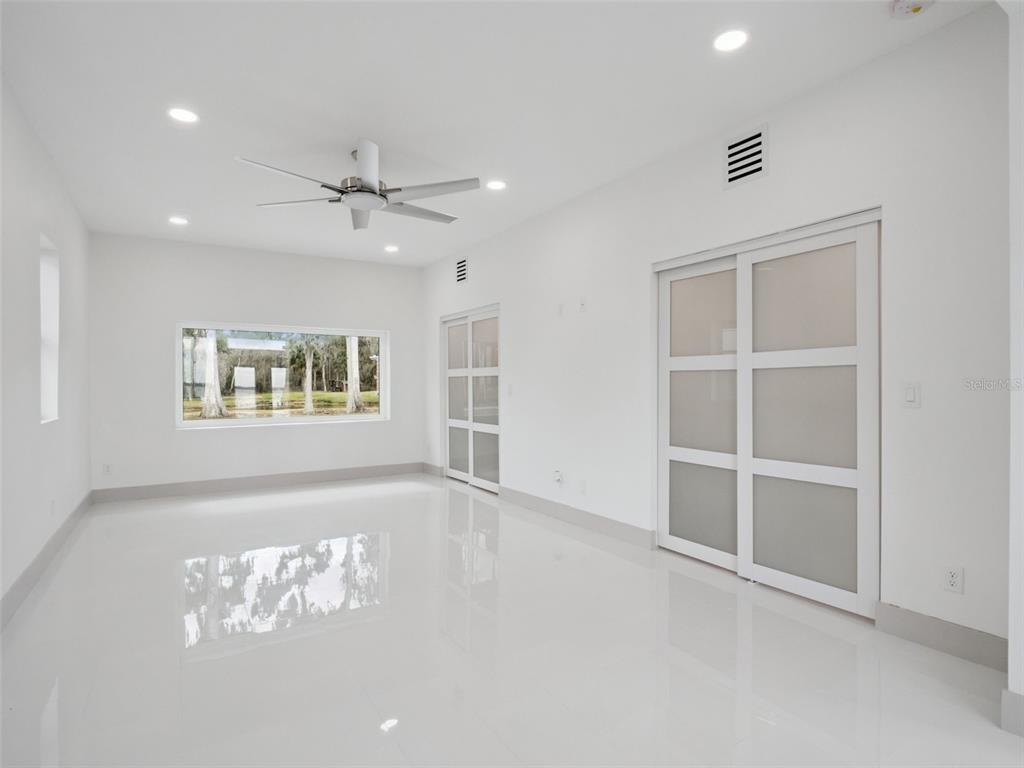 28055 Leuty Road Yalaha, FL 34797 - Photo 24 of 39 an empty room with windows and ceiling fan