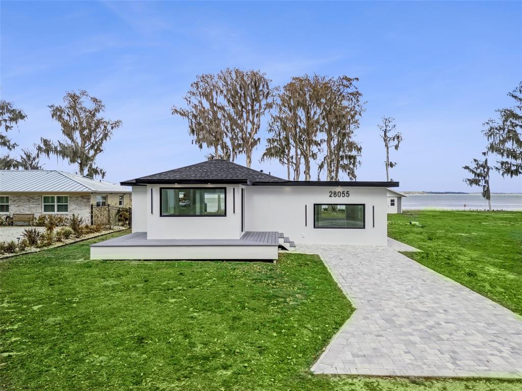 28055 Leuty Road Yalaha, FL 34797 - Photo 26 of 39 a front view of a house with a yard and garage