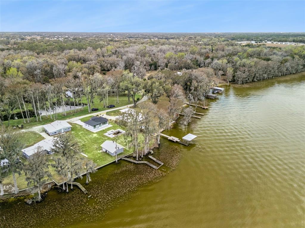 28055 Leuty Road Yalaha, FL 34797 - Photo 33 of 39 an aerial view of residential houses with outdoor space and lake view
