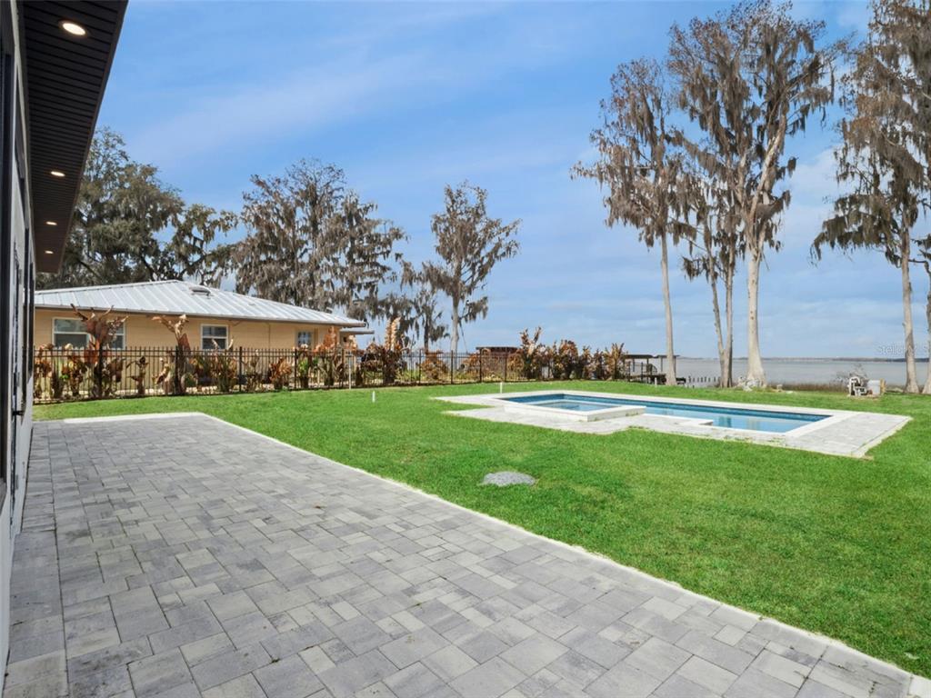 28055 Leuty Road Yalaha, FL 34797 - Photo 36 of 39 a view of a swimming pool and trees in the background