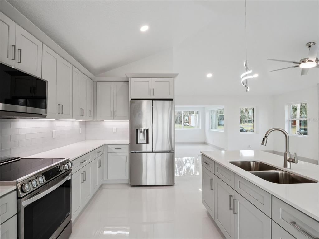 28055 Leuty Road Yalaha, FL 34797 - Photo 6 of 39 a kitchen with a sink stainless steel appliances and cabinets