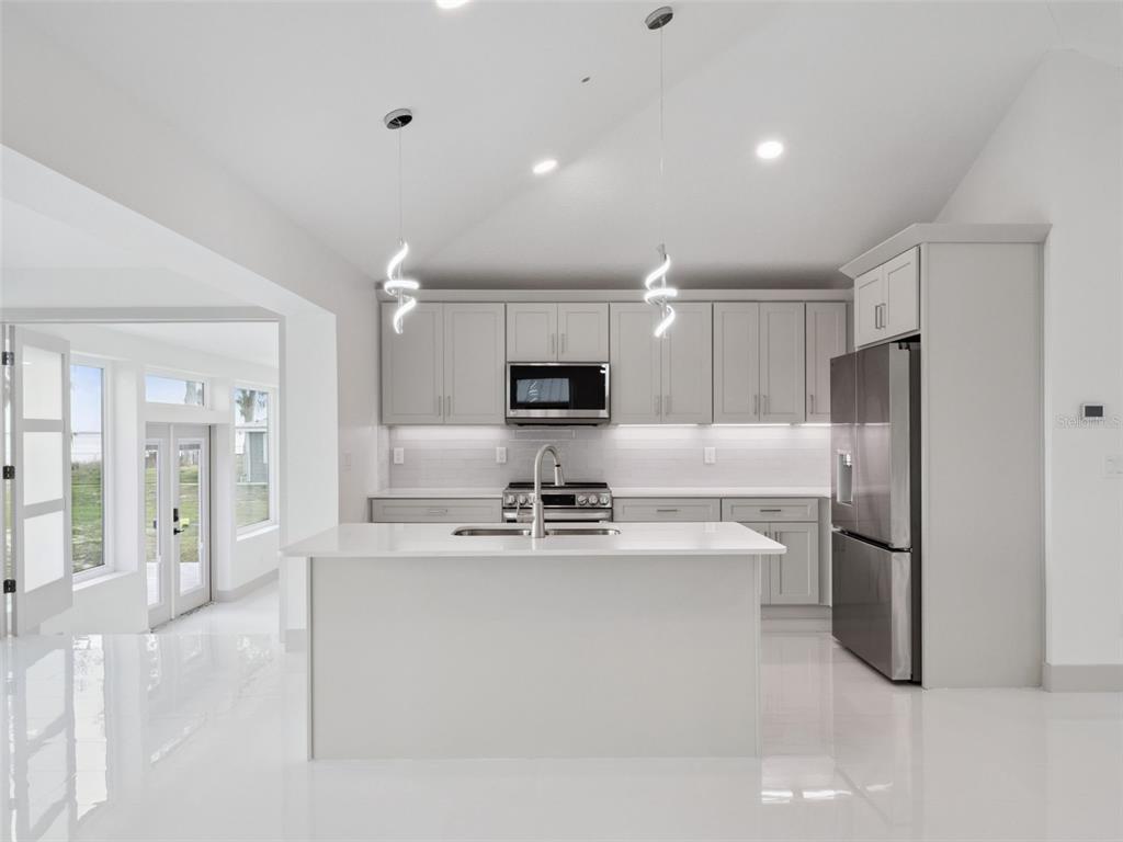 28055 Leuty Road Yalaha, FL 34797 - Photo 7 of 39 a kitchen with kitchen island a counter top space cabinets and stainless steel appliances