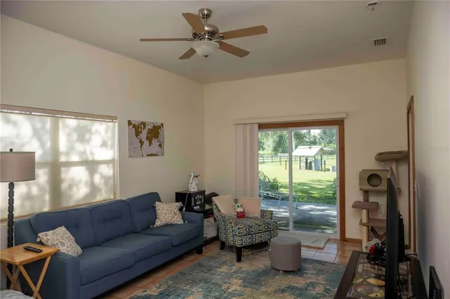 a front view of a house with a yard and potted plants