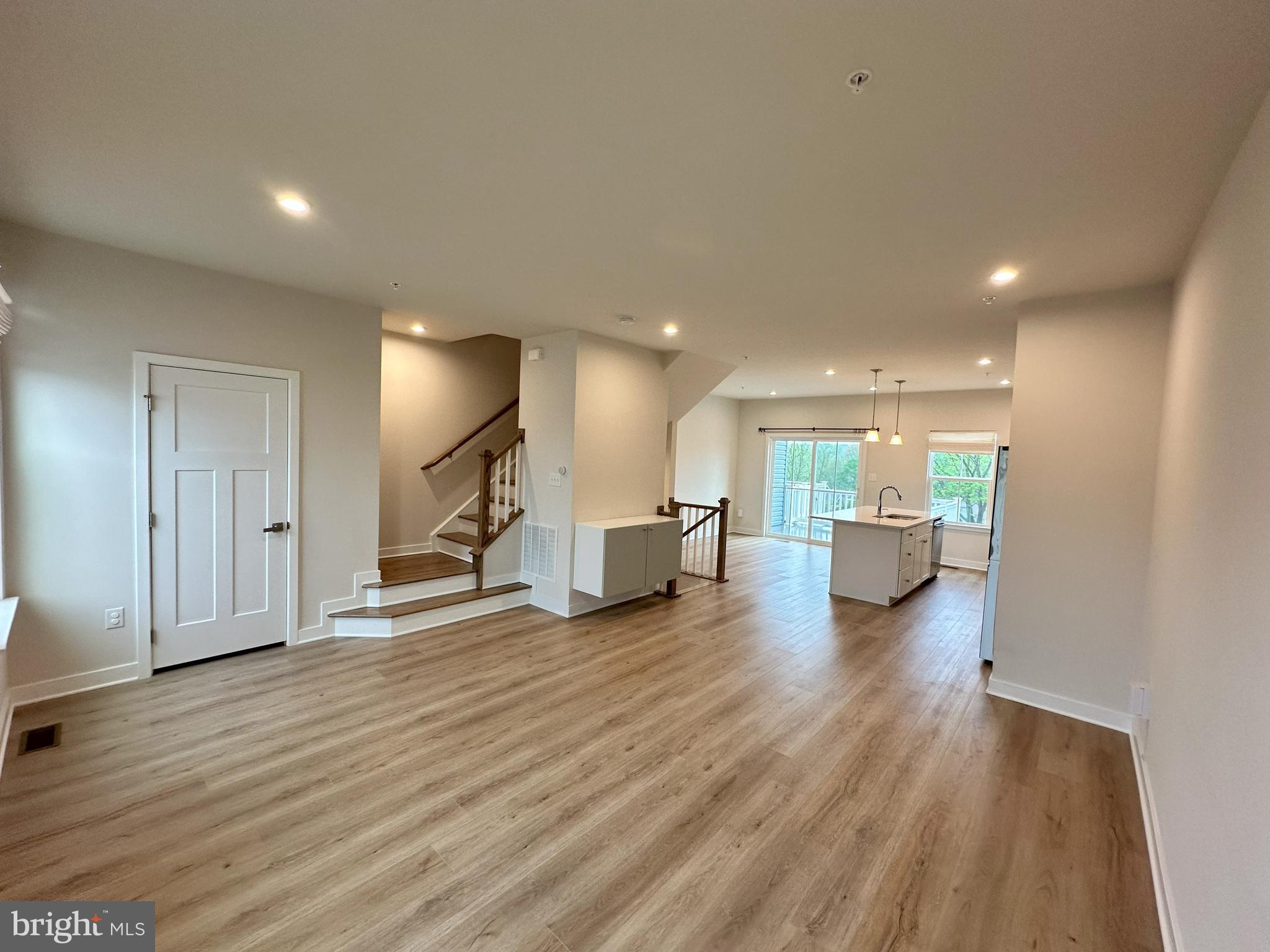 463 Paperbark Square Downingtown, PA 19335 - Photo 5 of 20 a view of a big room with wooden floor and windows