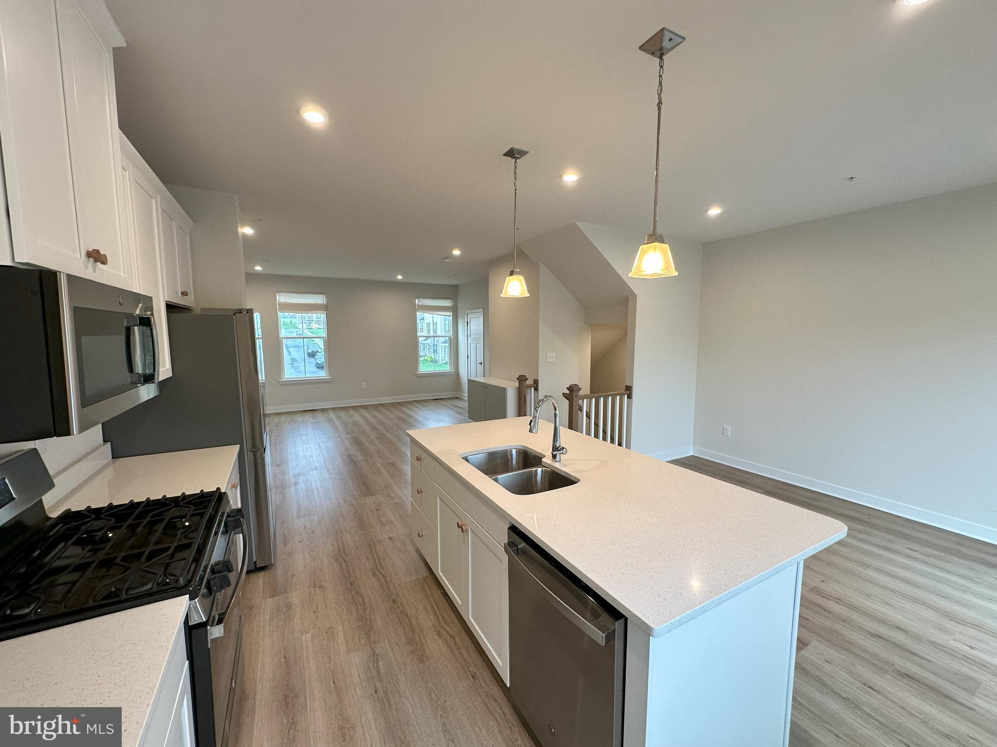 463 Paperbark Square Downingtown, PA 19335 - Photo 6 of 20 a kitchen with a sink a counter top space appliances and cabinets