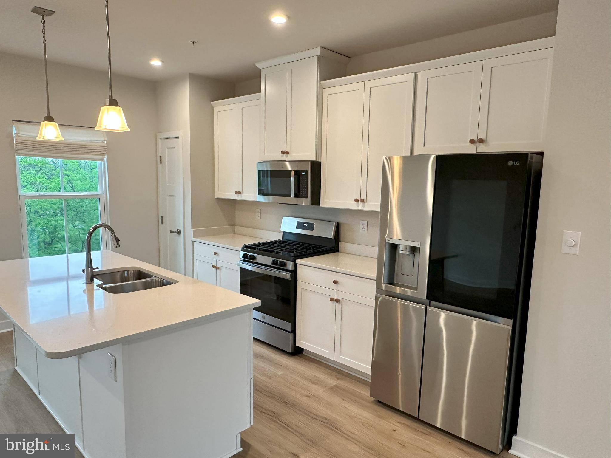 463 Paperbark Square Downingtown, PA 19335 - Photo 8 of 20 a kitchen with stainless steel appliances a refrigerator stove microwave and sink