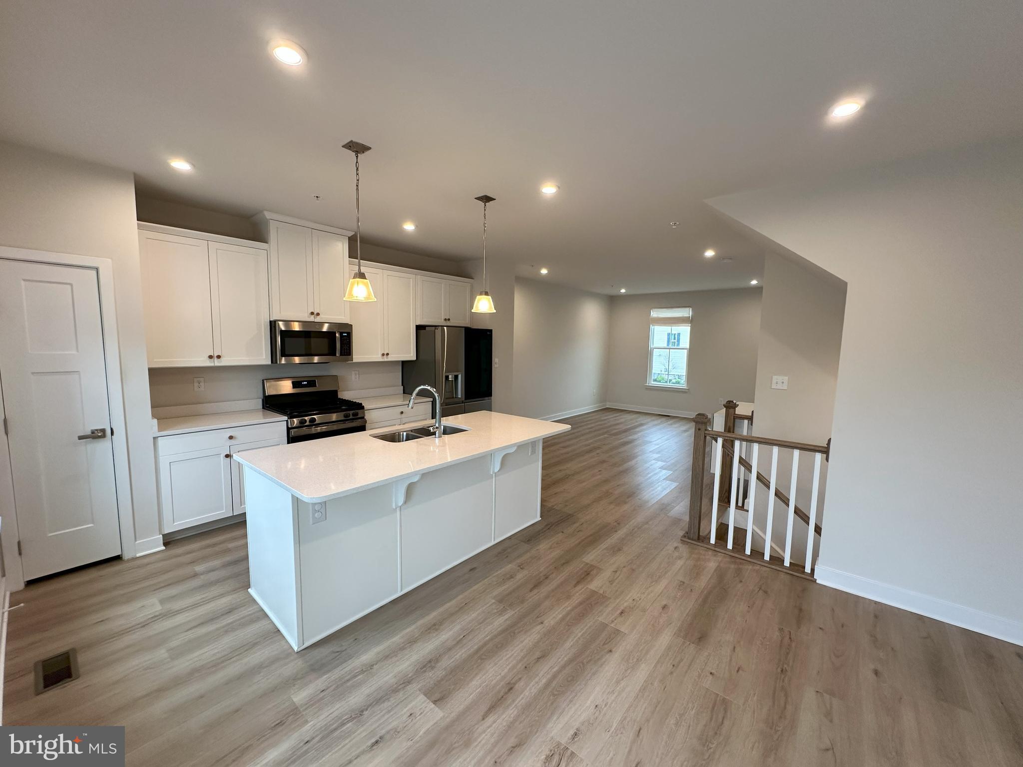 463 Paperbark Square Downingtown, PA 19335 - Photo 9 of 20 a large kitchen with stainless steel appliances refrigerator a stove top oven and a wooden floors