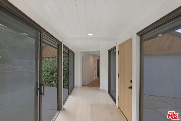 a kitchen with a sink and wooden floor