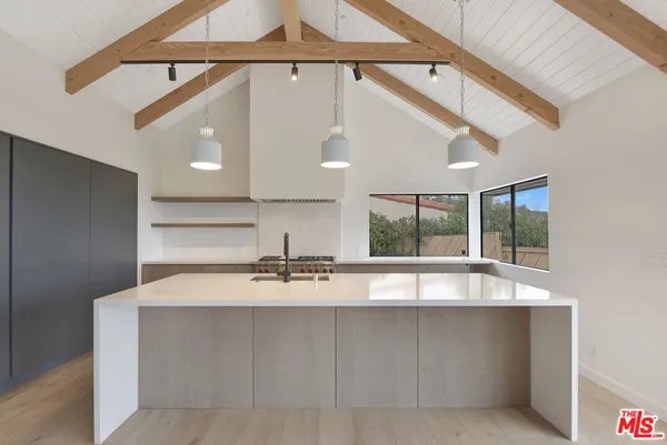 a view of a livingroom with furniture wooden floor and window