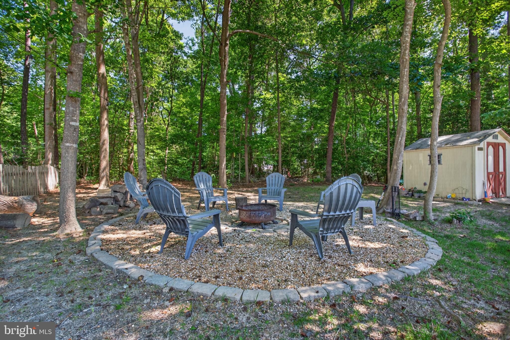 3917 Longhill Station Road Williamsburg, VA 23188 - Photo 23 of 29 Cozy fire pit nestled in nature.