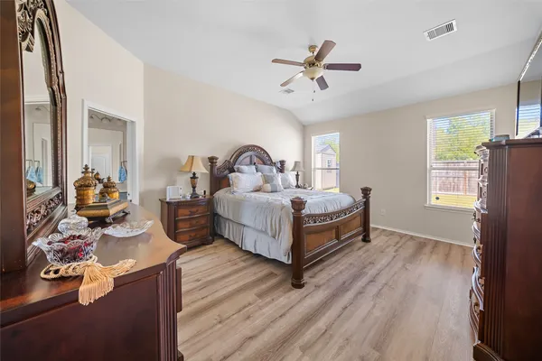 a bedroom with a bed and a chandelier