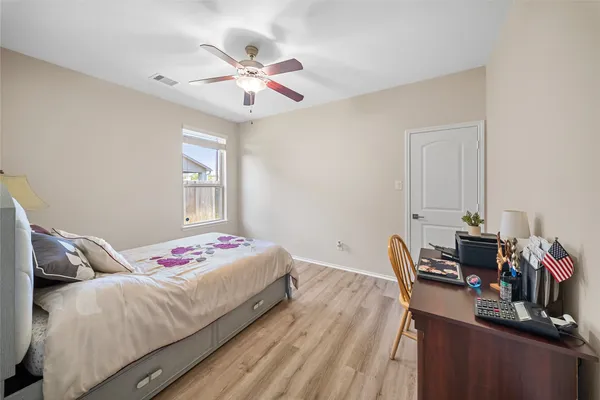 a bedroom with a bed and wooden floor