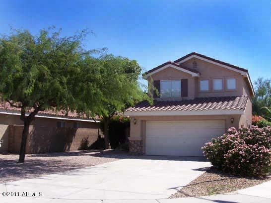 3213 East Marco Polo Road Phoenix, AZ 85050 - Photo 1 of 30 a front view of a house with a garden