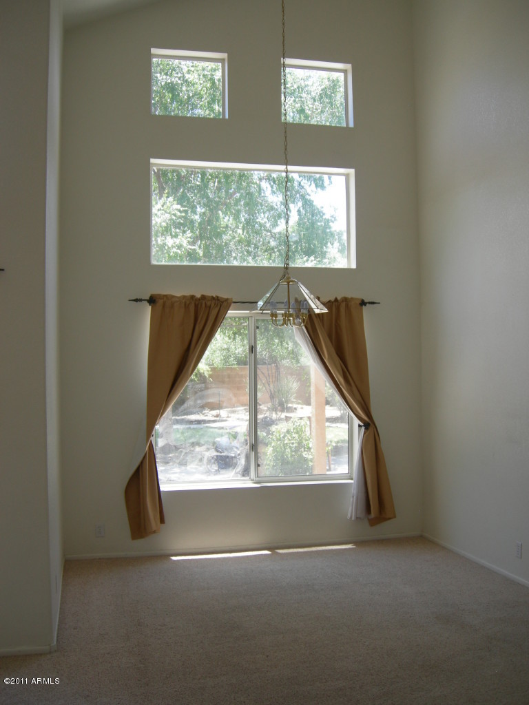 3213 East Marco Polo Road Phoenix, AZ 85050 - Photo 11 of 30 an empty room with a window