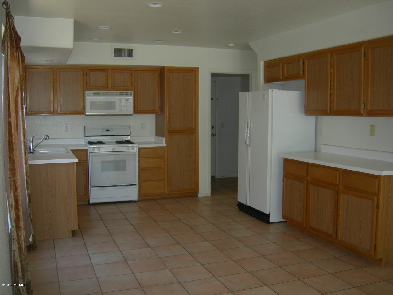 3213 East Marco Polo Road Phoenix, AZ 85050 - Photo 16 of 30 a kitchen with stainless steel appliances granite countertop a stove a refrigerator and a sink