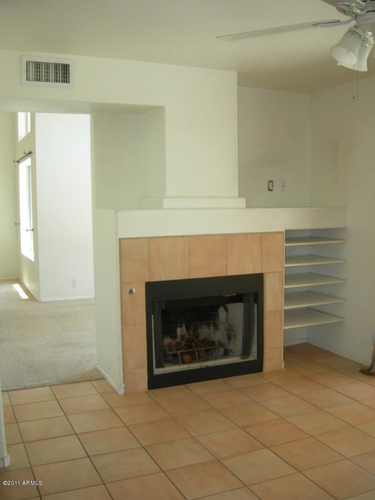 3213 East Marco Polo Road Phoenix, AZ 85050 - Photo 19 of 30 a living room with a fireplace