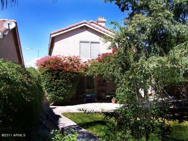 3213 East Marco Polo Road Phoenix, AZ 85050 - Photo 25 of 30 a front view of a house with a yard