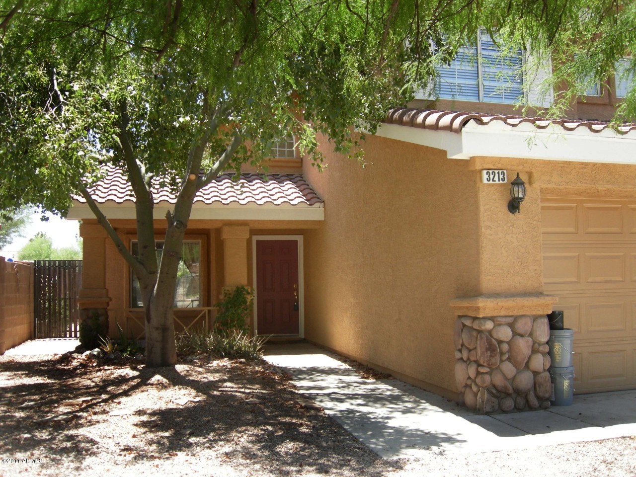 3213 East Marco Polo Road Phoenix, AZ 85050 - Photo 5 of 30 a view of a house with a tree