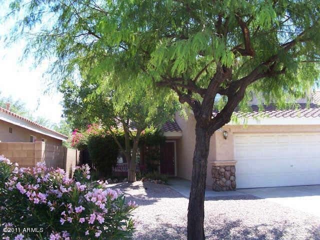 3213 East Marco Polo Road Phoenix, AZ 85050 - Photo 6 of 30 a front view of a house with a yard and tree