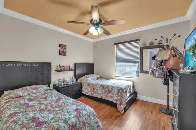 a bedroom with two beds and a chandelier