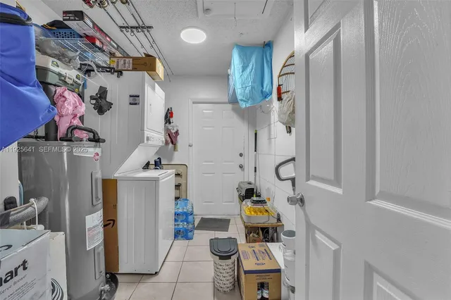 a view of storage and utility room with two washing machine