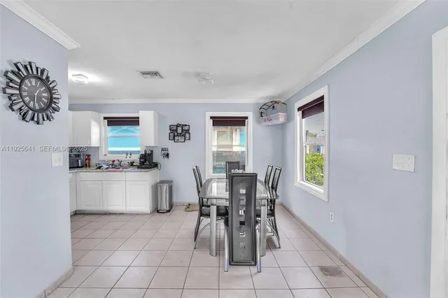 a kitchen with granite countertop a table and chairs in it